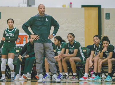  West Bloomfield coach Darrin McAllister and his team watch as West Bloomfield defeats Groves 82-30. 