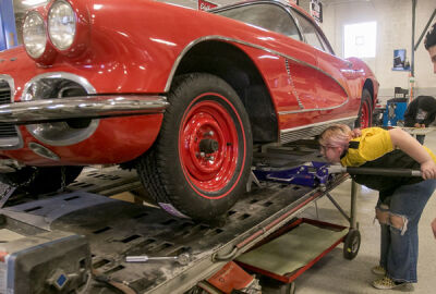  Kiley Robidou, a Fraser High School sophomore, uses a jack to raise up a 1962 Corvette so she can replace its drum brakes. 