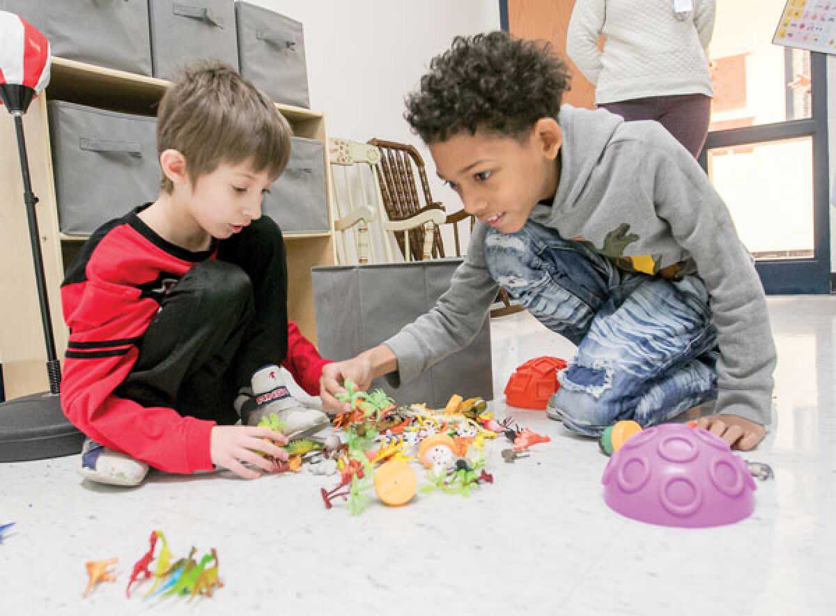  Kment first grader Landon Palomba, left, and third grader Javeon Hines explore the plastic toy animals inside the sensory room. 