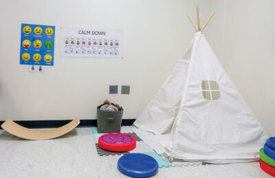  The Kment sensory room includes several pieces of equipment, including a tepee and calm-down chart. 