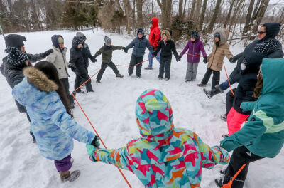  In a team building session, Novi fifth graders form a circle inside the rope during winter camp Jan. 30. They all had to cross over the rope one at a time without letting the rope fall to the ground. 