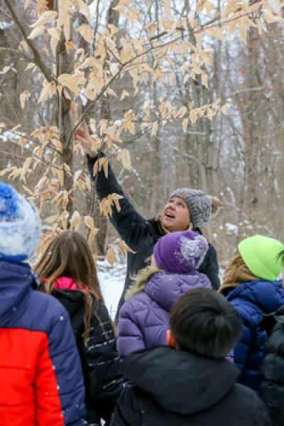  Walled Lake Outdoor Education Center facilitator Jen DeVooght talks with Novi fifth graders during a hike Jan. 30. 