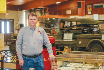  Chris Causley, president of the Michigan Military Technical & Historical Society Museum in Eastpointe, stands inside the museum along with various military vehicles and memorabilia. 