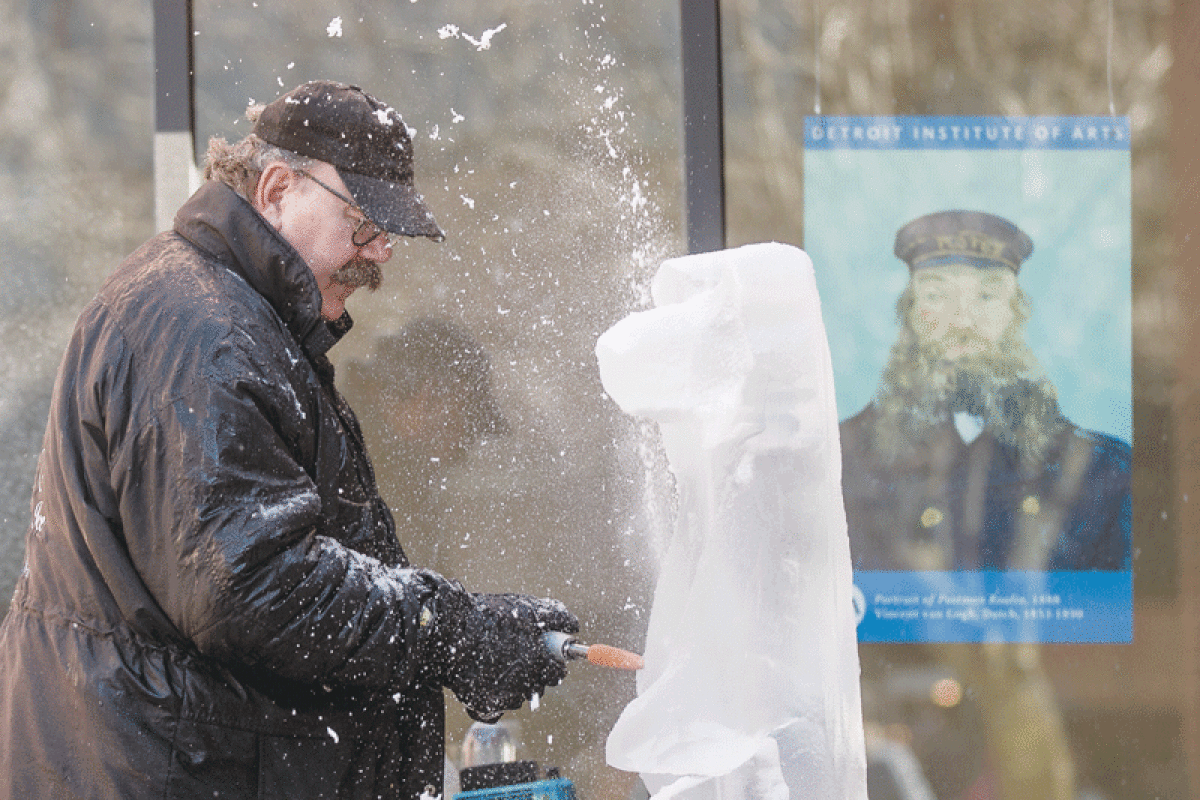 Ray Lucier, a carver for Finesse Ice, works on an ice sculpture of a bear at the 2023 Mount Clemens Ice Carving Show. 