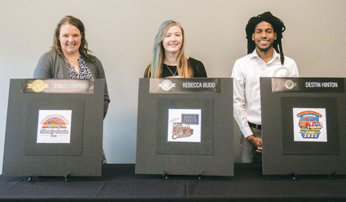 From the left stands first-place winner Emily Cooper, second-place winner Rebecca Budd and third-place winner Destin Hinton in front of their winning designs.  