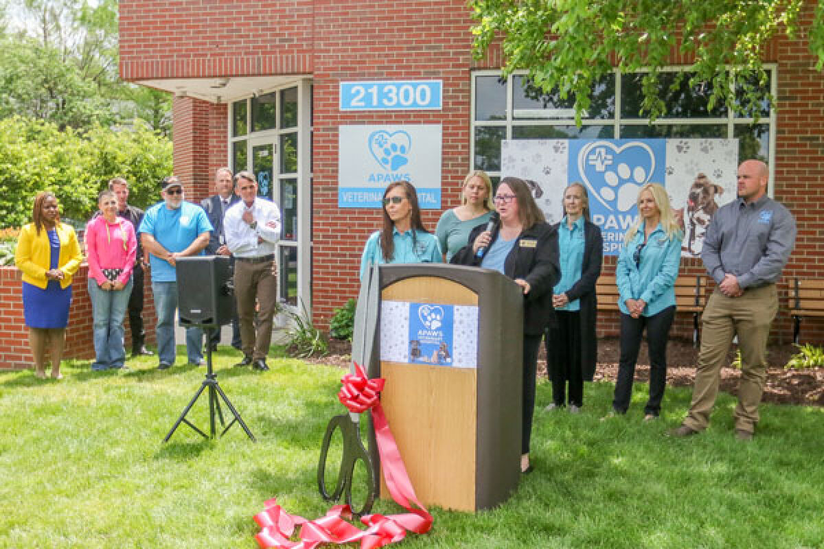  Sandra Maki, event coordinator for the Eastpointe-Roseville Chamber of Commerce, leads the ribbon cutting ceremony for APAWS in Eastpointe June 10. To her right is Theresa Sumpter, executive director for both APAWS and Detroit Pit Crew. 
