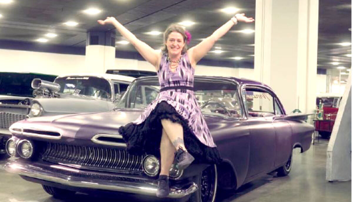  Doni Muzzy strikes a pose while sitting on her 1959 Chevrolet Custom, affectionately referred to as “Ramona” and the “Big Ass Purple Car.” The photo was taken during filming for the upcoming Keith Famie documentary “Detroit: A City of Hot Rods and Muscle Cars.” 