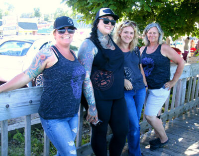  From left, Throttle Gals staff Keri Porter, Trish Horstman, Doni Muzzy and Jeni Witte pose while working at the car show in St. Ignace, Michigan. 