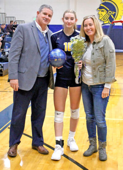  Verner poses for a picture with her parents, Ted and Nancy, during her senior night for volleyball. 