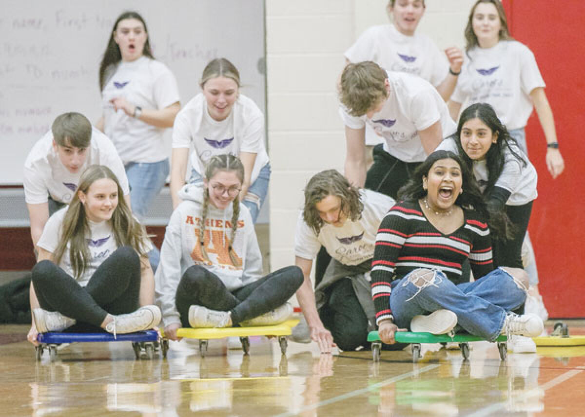  Athens High School students take part in the Mario Kart race, making laps around the gym floor while avoiding balls being thrown at them, as part of 2023 Charity Week. 
