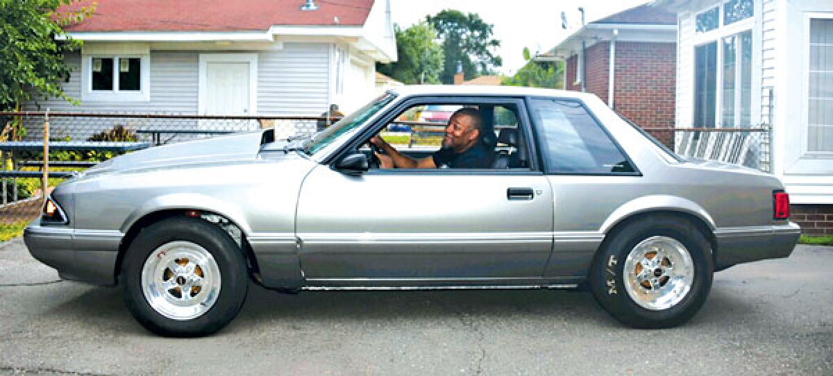  Jay Thomas, of Southfield, poses in his 1992 Ford Mustang. 