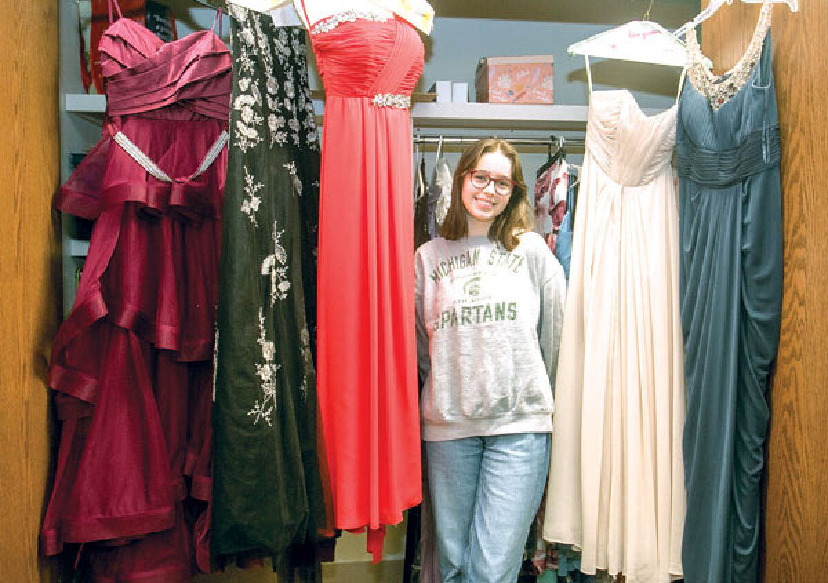  Novi High School senior Stella Camerlengo, 17, shows some of the dresses she has collected so far for her incubator entrepreneur class project, the Promject. 