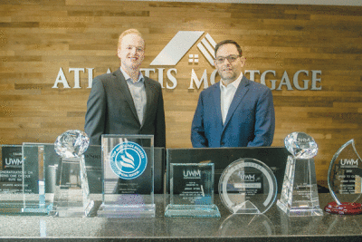  Atlantis Mortgage Executive Loan Officer Thomas Naughton, left, and Atlantis Mortgage Vice President Jeremy Stybel stand with some of their awards at their Farmington Hills office.  