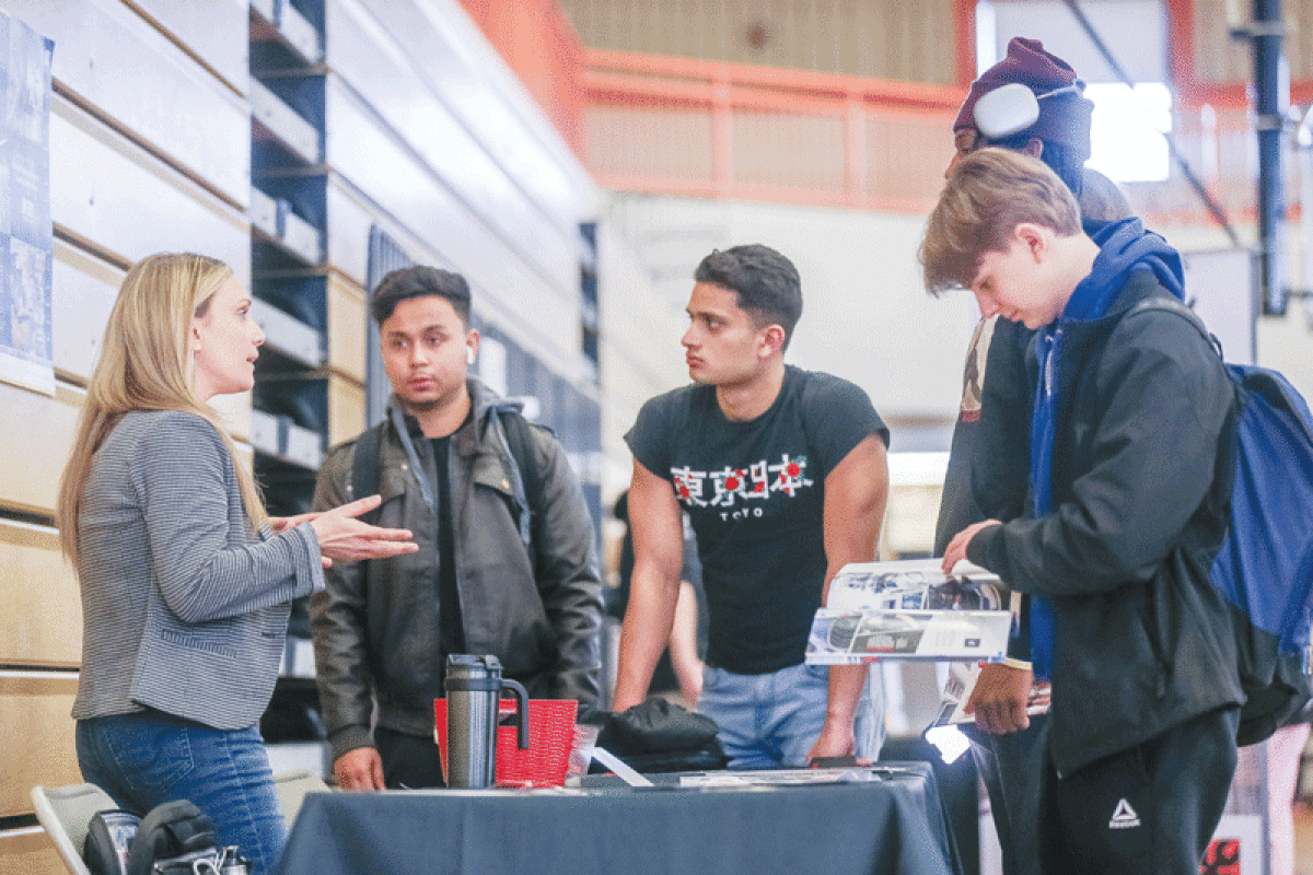   Rita Hamed, field admission representative for Universal Technical Institute, talks with Center Line High School students about different opportunities in the skilled trades field.  