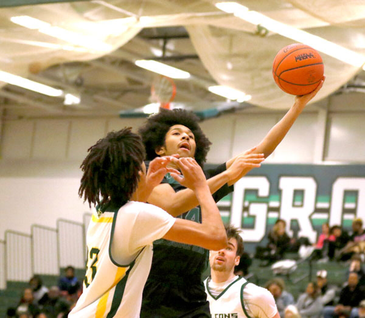  West Bloomfield sophomore guard Tory James attempts a contested layup in West Bloomfield’s game against Birmingham Groves Feb. 14 at Groves High School. 