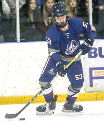  St. Clair Shores Unified freshman Zach Delmonte controls the puck during SCS Unified’s regional finals game against Warren De La Salle Collegiate on March 1 at Mt. Clemens Ice Arena. 