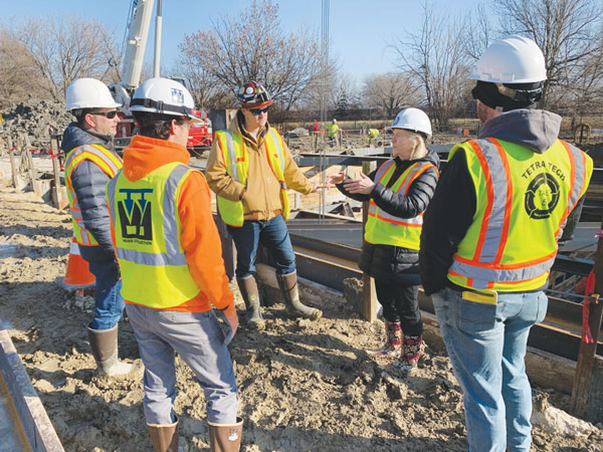  Macomb County Public Works Commissioner Candice Miller, center, discusses a construction project aimed at reducing combined sewer overflows into Lake St. Clair with engineers. 