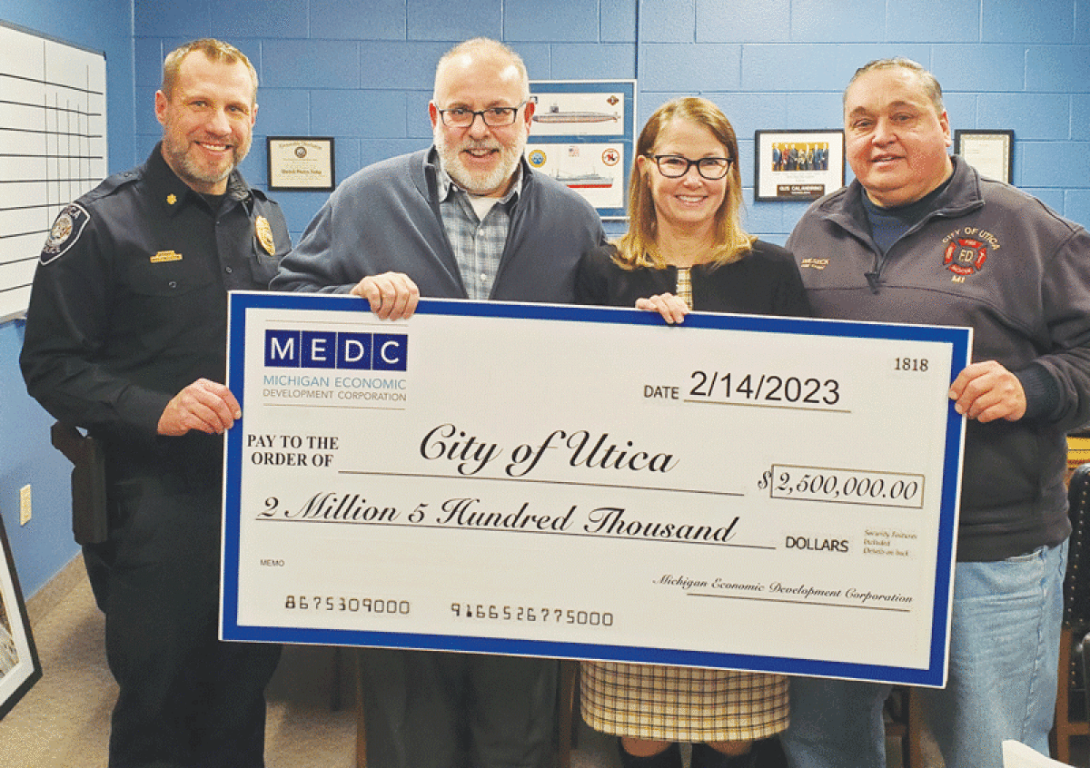  Pictured from left, Utica Deputy Police Chief Matt Kaluzny, Mayor Gus Calandrino, former state Rep. Diana Farrington and Fire Chief Kevin Wilseck celebrate the $2.5 million Michigan Enhancement Grant that the city  recently received. 