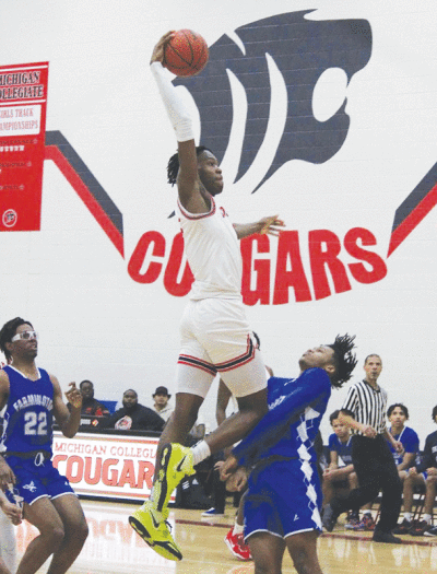  Warren Michigan Collegiate junior Dylan Grant goes for the dunk during Michigan Collegiate’s  game against Farmington on Feb. 2 at Michigan Collegiate High School.  