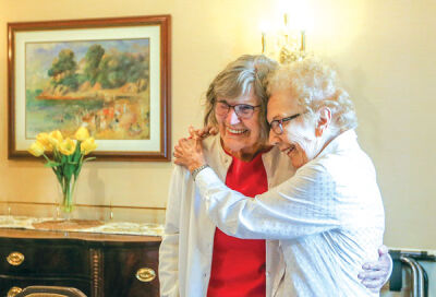  Waltonwood Twelve Oaks staff arranged for Joy Klomp, 86, left, to fly in from California to surprise her sister, Carol Timmer, 91, right, at the Novi senior living facility where Timmer resides. Klomp and Timmer had not seen each other in five years, and Timmer mentioned at a Waltonwood event that she wished she could see her sister again.  