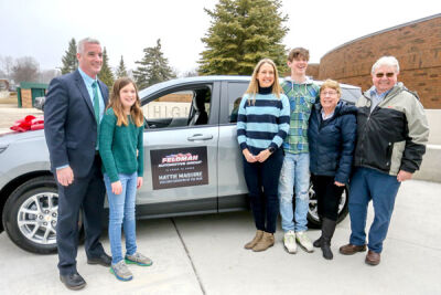  Maguire and her family pose for a photo with the new SUV. From left are Maguire’s husband, Patrick; daughter Molly; Maguire; son Charlie; and her parents, Lois and Tom Tackebury. 