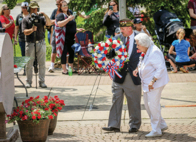  At a memorial service following the last Madison Heights Memorial Day Parade — held May 25, 2019, the weekend before Memorial Day — Norm Maudlin, senior vice commander of VFW District V,  escorted Gold Star mother Jean Linville in the laying of the wreaths. 