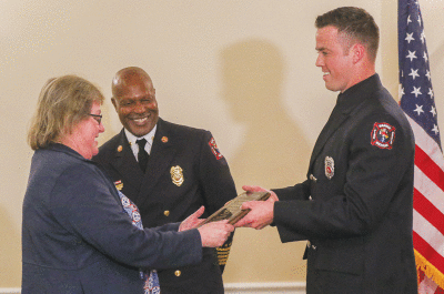   Fran Zick, from Meijer, received an award from the Warren Fire Department for public service on March 8. She was greeted at the ceremony by Fire Chief Orin Ferguson, left, and Kyle Morrow.  