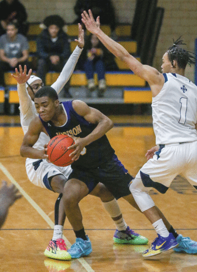  Madison senior Damian Harvey Jr. fights through a double team against Detroit Loyola on March 10 at Detroit Pershing High School. 