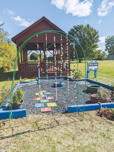  The Burr Elementary School sensory garden includes a bottle-cap curtain and hopscotch at its entrance. 