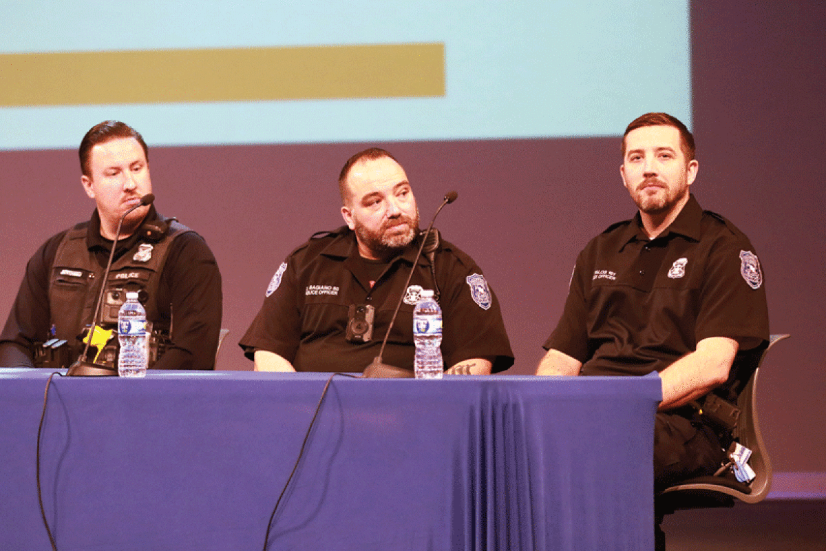  Sterling Heights police officer Duane Casbar, left, and Warren police officers Darryl Bagiano, center, and John Talos provide information to parents and students during the event. All three law enforcement officials are school resource officers in Warren Consolidated Schools. 