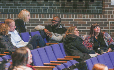   A couple of times during the evening, author Rosalind Wiseman encouraged the audience members to discuss matters she brought up at the presentation. Pictured here is Warren Woods Public Schools Superintendent Stacey Denewith-Fici, sitting in the top row. 