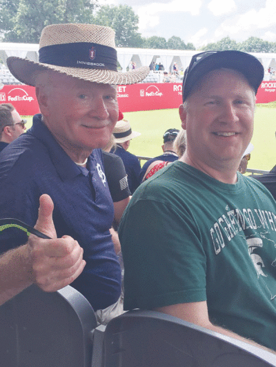  Rolling Stones fan Richard McMahon, left, wrote a story on the famous band that was published in a book written by British music author Richard Houghton.  McMahon is pictured here with his stepson, Derek Woelke, at the Rocket Mortgage Classic three years ago at the Detroit Golf Club. 