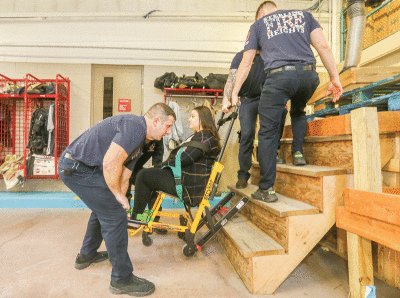 The SHFD demonstrates how a stair chair can move a person. 