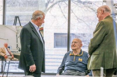  Bigelow speaks with some of his colleagues at his 100th birthday party. 