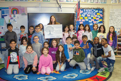  Holden Elementary School second grade teacher Michelle Clarke, surrounded by students, is the Outstanding Teacher of the Year at the elementary level in the Warren Consolidated Schools district. 
