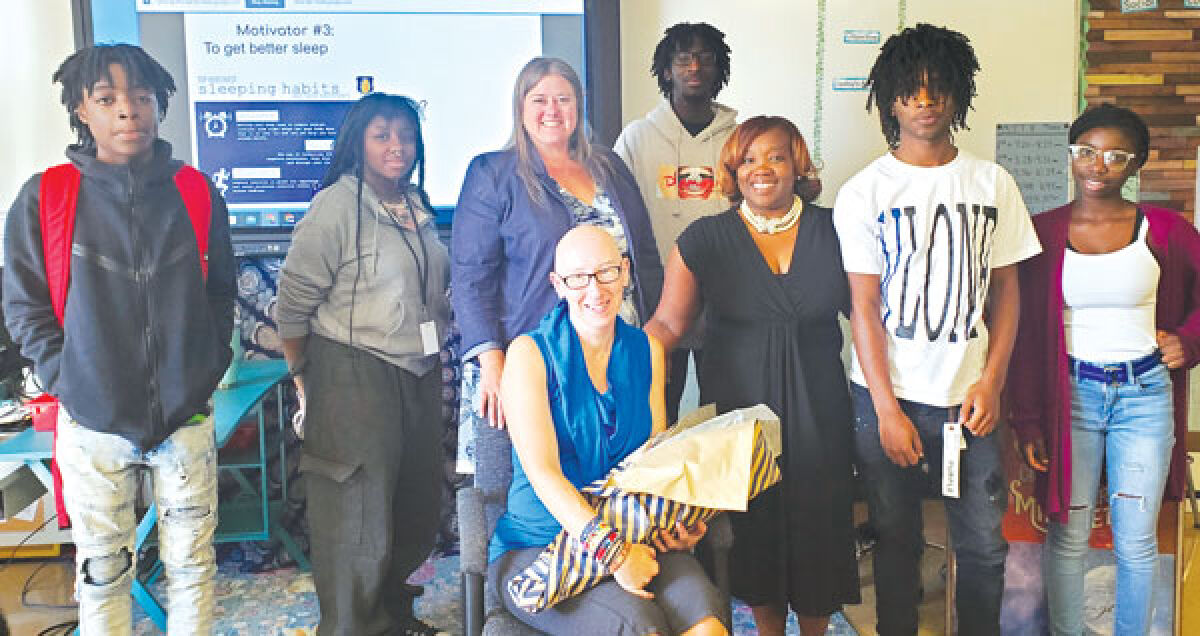  Eastpointe High School health teacher Katie Belemonti receives congratulations after being named the Outstanding Teacher of the Year at the high school level. 