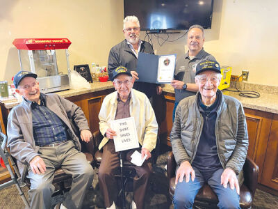  Mike Aleo, front center, is honored alongside fellow World War II veterans William Sengstock, front left, and Jack Gilliand, front right, by Paul Palazzolo, the president of Chapter 9 of the Vietnam Veterans of America in Detroit, back left, and Aleo’s son, Steve. 