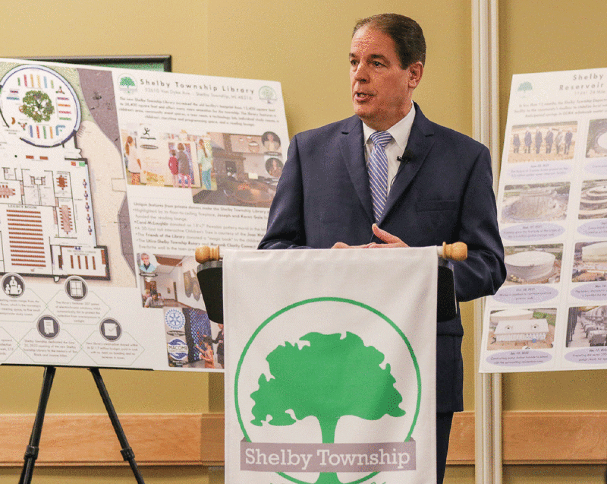  With posters full of information about the new Shelby Township Library and the Shelby Township Water Reservoir in the background, Supervisor Rick Stathakis delivers the State of the Township address March 24 at the Amazon fulfillment center on Mound Road. 