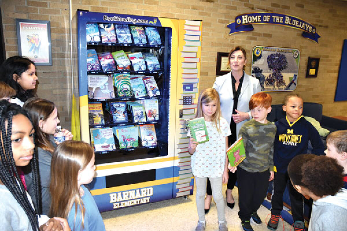  Barnard Elementary Principal Melanie Morey shows several of her students the new book vending machine the school had installed March 22. 