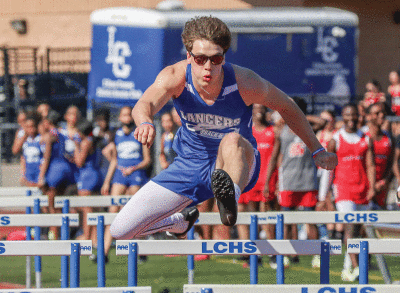  L’Anse Creuse senior Chad Jacobs runs the 110-meter hurdles during L’Anse Creuse’s first outdoor dual meet against St. Clair Shores Lake Shore High School on April 12 at L’Anse Creuse High School. 