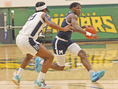  Freshman guard Tamario Adley, who finished second in scoring on the team this season, controls the ball. 