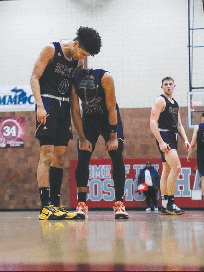   Warren De La Salle senior Nino Smith, left, has a conversation with sophomore standout Phoenix Glassnor during a game against  Hamtramck High School on March 10. 