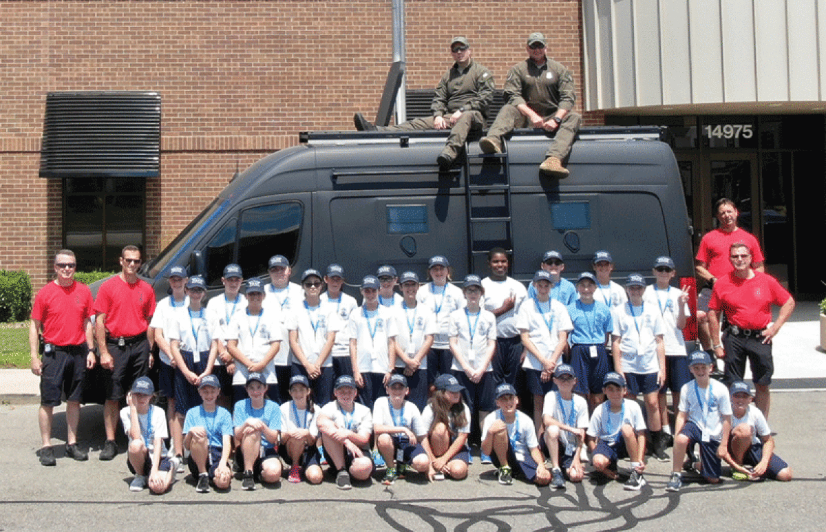  A previous Shelby Township Police Department Youth Law Enforcement Academy poses for a photograph at the Shelby Township Senior Activities Center. 