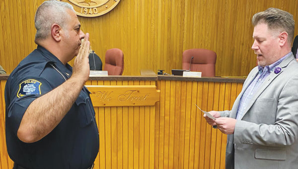  Clawson City Clerk August Glitschlag swears in Vincent Smith, who retired as chief of the Harper Woods Public Safety Department, to the position of interim police chief May 5. 