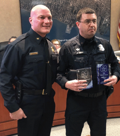  Grosse Pointe Shores Public Safety Director Kenneth Werenski presents Sgt. Jason Cook with honors that include the director’s award for Officer of the Year for his exemplary service in 2022. 
