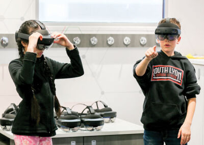  Mia Kiuchi and Caden Steslicki try out the STEMi Truck’s mixed reality headsets. 
