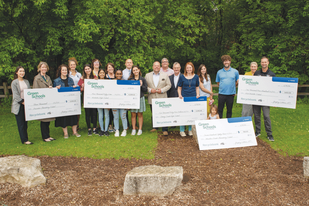  Leaders from the city of Rochester Hills pose for a photo with Recyclebank grant winners from Rochester Community Schools during a previous grant cycle. 