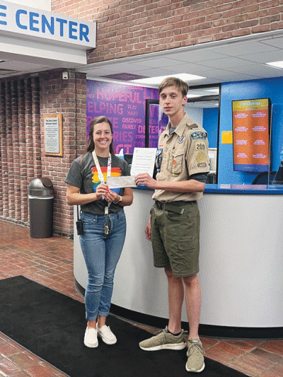   Alexander Shunk, 16, poses with a representative from the YMCA. Shunk made four picnic tables for his local YMCA as his Eagle Scout project. 