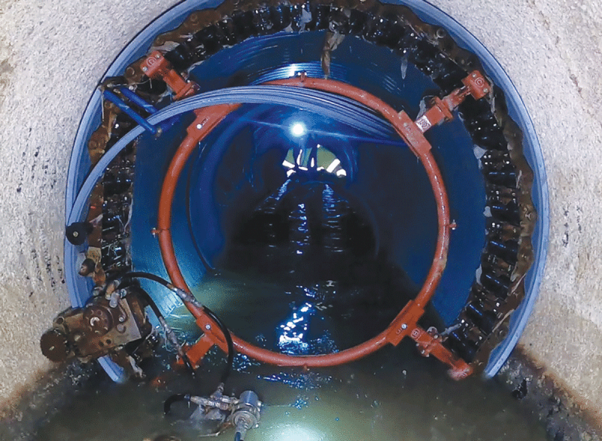  This photo shows the spiral-wound pipe lining of the Garfield Interceptor sewer beneath Garfield Road at 21 Mile Road in Macomb Township as it is installed by SAK Construction contractors. 