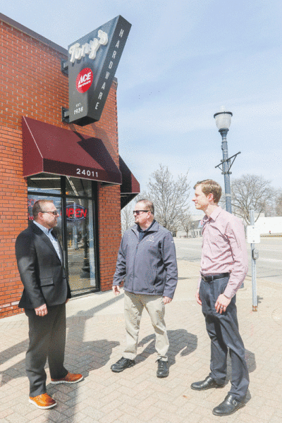  State Rep. Mike McFall, D-District 8, meets with Ed Klobucher, the city manager of Hazel Park, and James Finkley, Hazel Park’s planning and economic development director, outside Tony’s Ace Hardware in Hazel Park April 10. The city has applied for a federal grant that would enhance the city’s downtown district and improve accessibility there. 